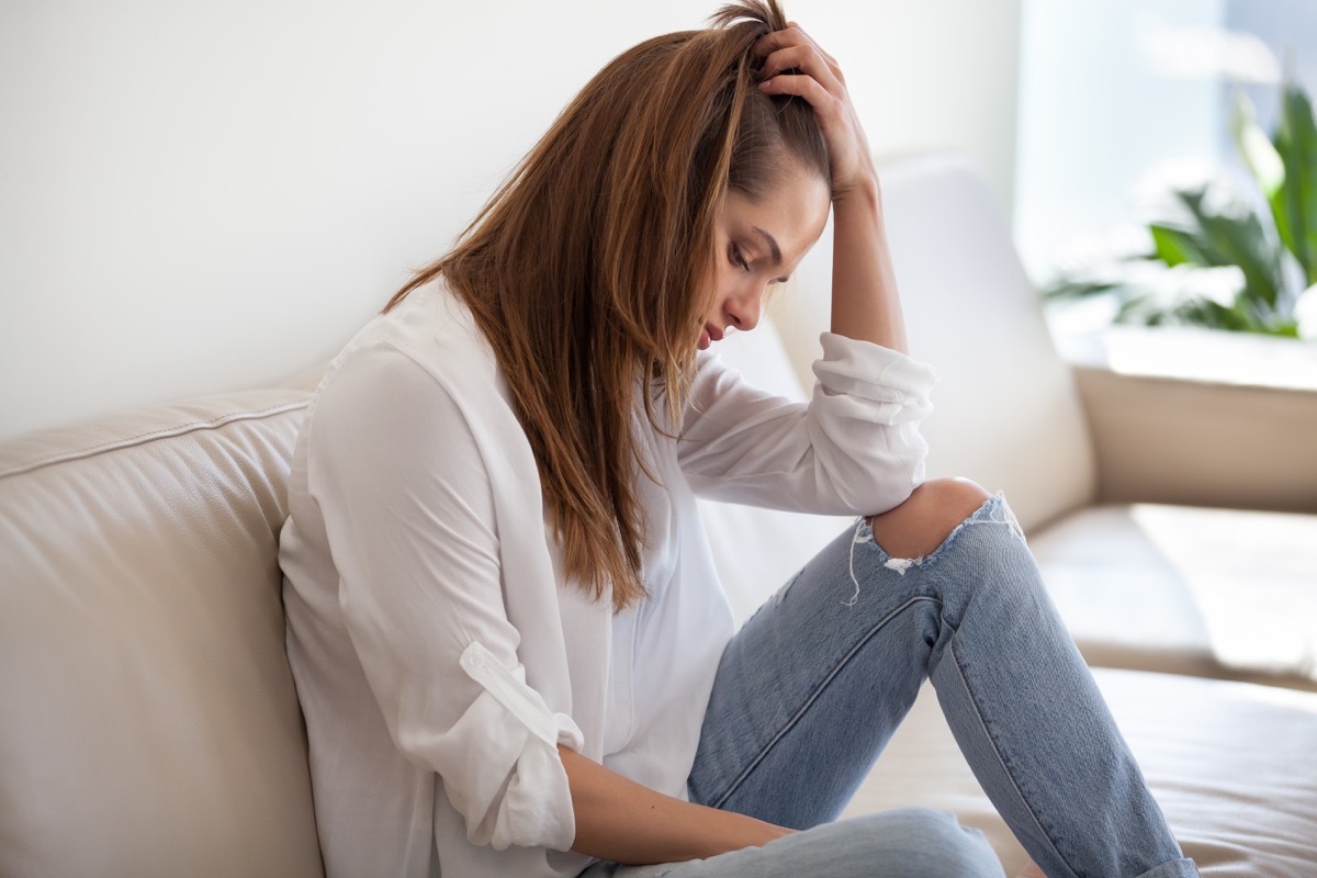 Woman is sad and depressed on the couch