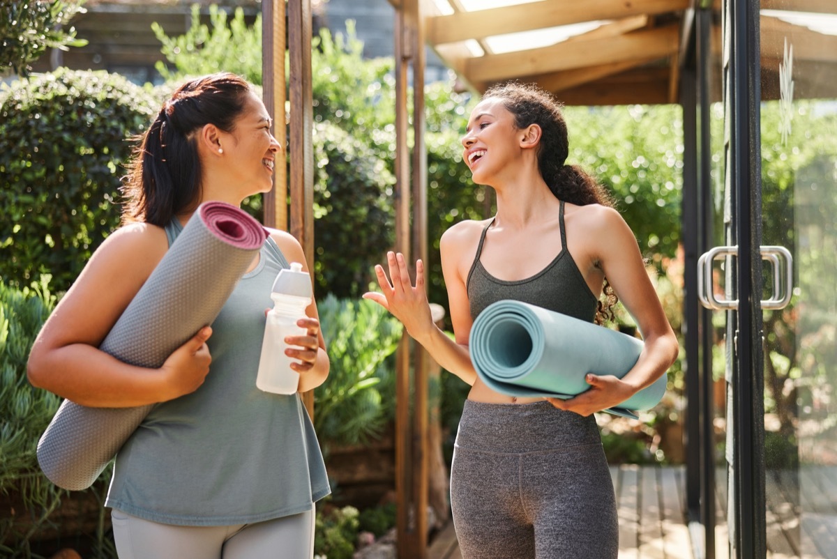 two female friends talking after a yoga class