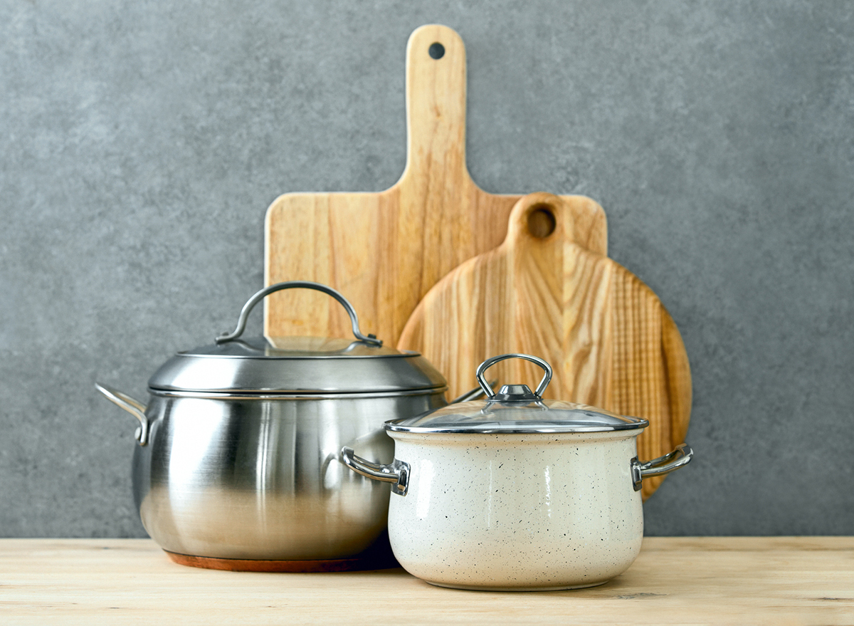 trendy cooking pots with lids and cutting boards