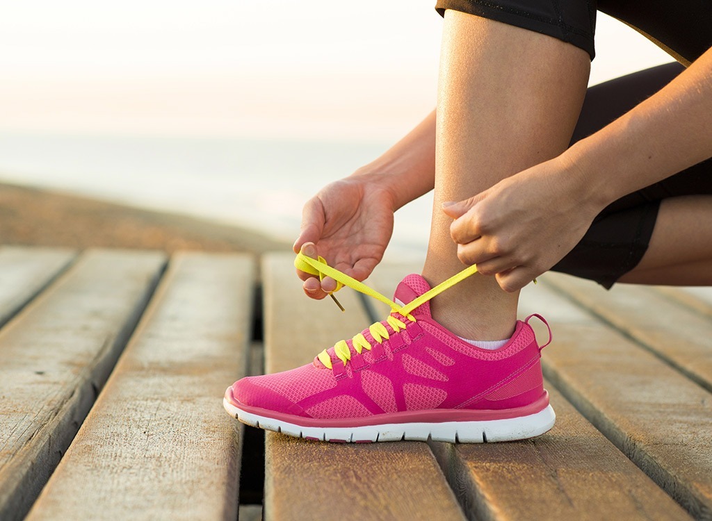 Woman lacing shoes