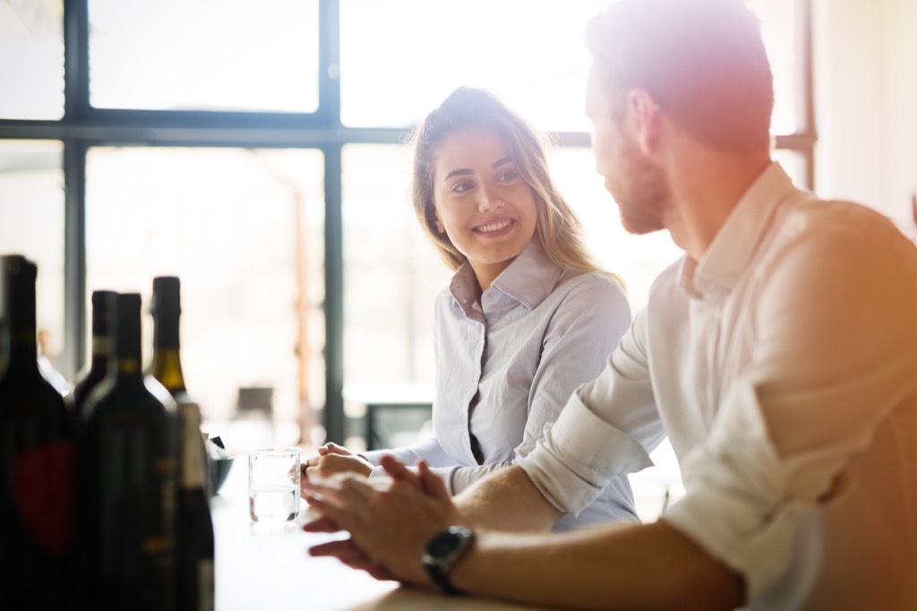 Woman smiling, bar what women want to hear