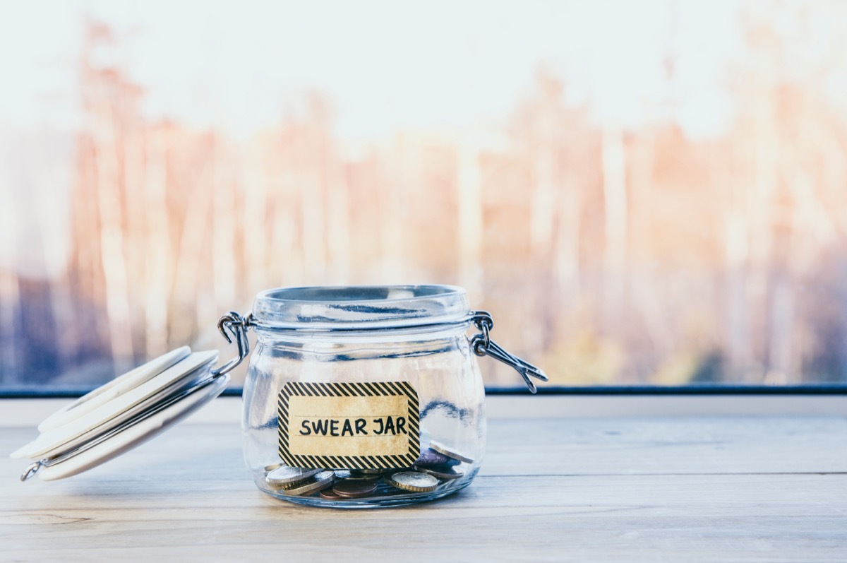 swear jar against city background