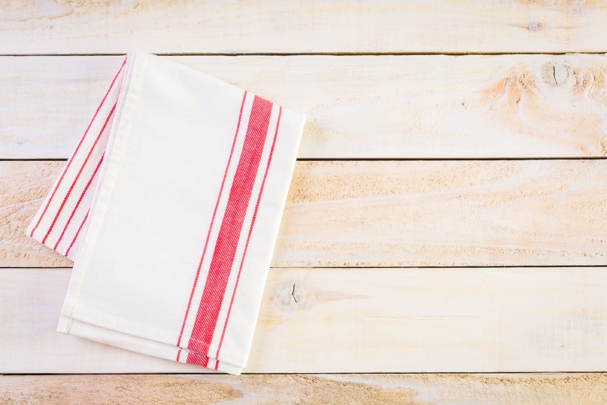 dish towel folded on wood background