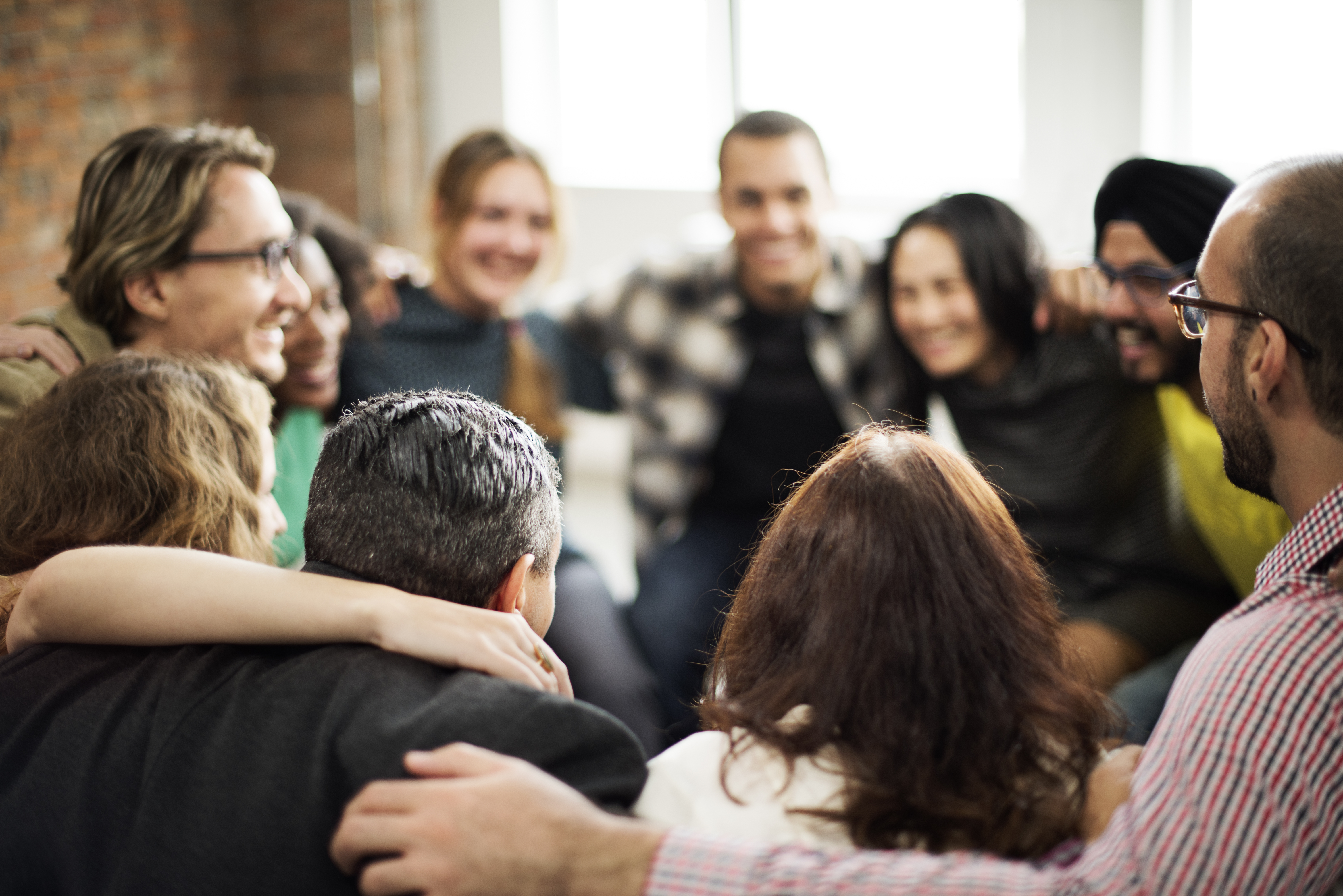 office workers huddled together thinking of a funny team name